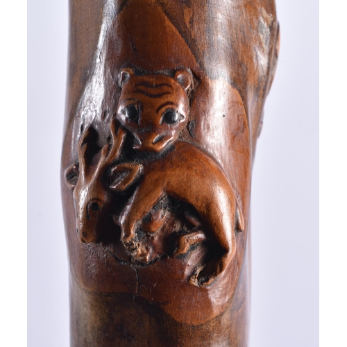 104 - AN 18TH/19TH CENTURY CONTINENTAL CARVED FOLK ART WOOD WALKING CANE formed with grotesque beasts and ... 