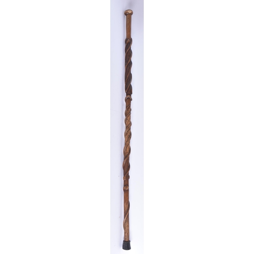 106 - A 19TH CENTURY CONTINENTAL CARVED ENTWINED SNAKE WOOD WALKING CANE. 90 cm long.