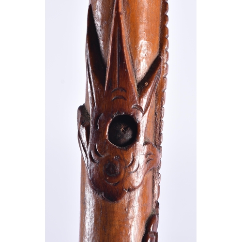 107 - A 19TH CENTURY JAPANESE MEIJI PERIOD CARVED WOOD WALKING CANE overlaid with a dragon. 92 cm long.