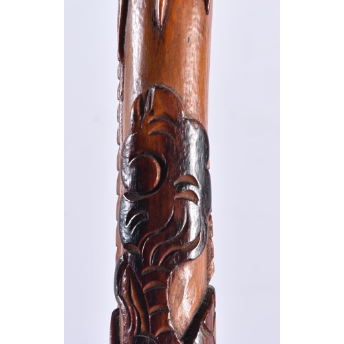 107 - A 19TH CENTURY JAPANESE MEIJI PERIOD CARVED WOOD WALKING CANE overlaid with a dragon. 92 cm long.