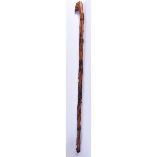 107 - A 19TH CENTURY JAPANESE MEIJI PERIOD CARVED WOOD WALKING CANE overlaid with a dragon. 92 cm long.