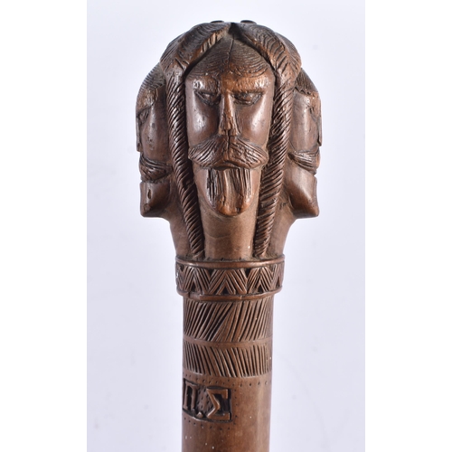 108 - AN 18TH/19TH CENTURY GREEK CARVED WOOD WALKING CANE formed with mask heads. 80 cm long.