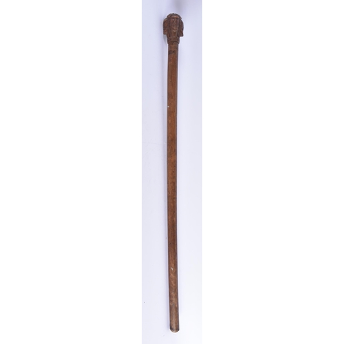 108 - AN 18TH/19TH CENTURY GREEK CARVED WOOD WALKING CANE formed with mask heads. 80 cm long.