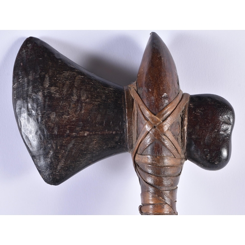 109 - AN EARLY 20TH CENTURY CONTINENTAL TRIBAL CARVED WOOD AND SNAKE SKIN AXE. 54 cm long.