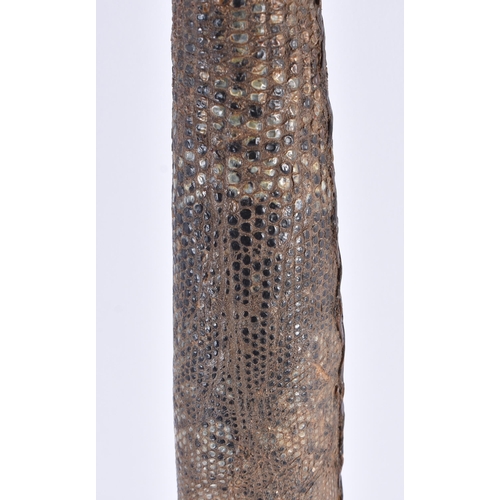 109 - AN EARLY 20TH CENTURY CONTINENTAL TRIBAL CARVED WOOD AND SNAKE SKIN AXE. 54 cm long.