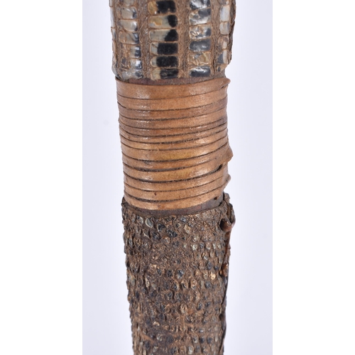 109 - AN EARLY 20TH CENTURY CONTINENTAL TRIBAL CARVED WOOD AND SNAKE SKIN AXE. 54 cm long.