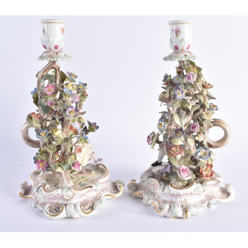 11 - A PAIR OF 19TH CENTURY MEISSEN PORCELAIN FIGURAL CANDLESTICKS modelled with figures dancing under fo... 