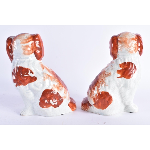 115 - A PAIR OF 19TH CENTURY STAFFORDSHIRE RED SPANIELS. 17 cm high.