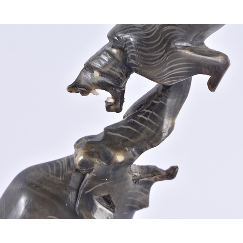 116 - A 19TH CENTURY ANGLO INDIAN CARVED RHINOCEROS HORN ELEPHANT modelled holding aloft a lion. 25 cm hig... 