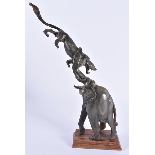 116 - A 19TH CENTURY ANGLO INDIAN CARVED RHINOCEROS HORN ELEPHANT modelled holding aloft a lion. 25 cm hig... 