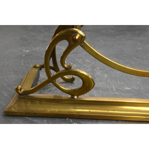 118 - AN ART NOUVEAU BRASS FENDER. 127 cm wide.