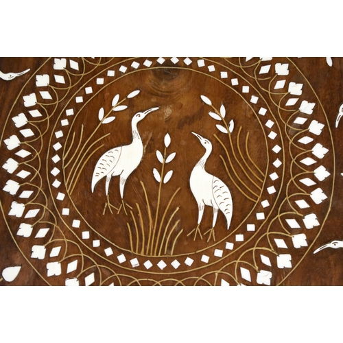 120 - AN EARLY 20TH CENTURY ANGLO INDIAN CARVED WOOD TABLE decorated with birds within landscapes. 45 cm x... 