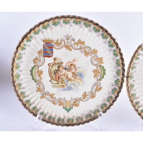 128 - A PAIR OF 18TH CENTURY CONTINENTAL FLUTED POTTERY DISHES painted with putti. 25 cm wide.