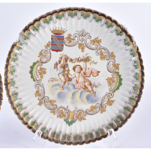 128 - A PAIR OF 18TH CENTURY CONTINENTAL FLUTED POTTERY DISHES painted with putti. 25 cm wide.