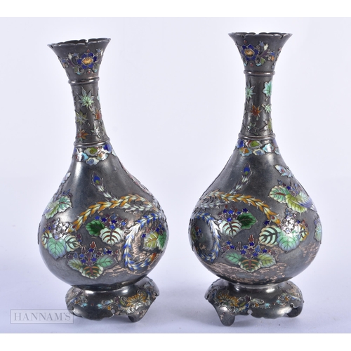 130C - A FINE PAIR OF 19TH CENTURY JAPANESE MEIJI PERIOD SILVER AND ENAMEL VASES decorated with birds and f... 