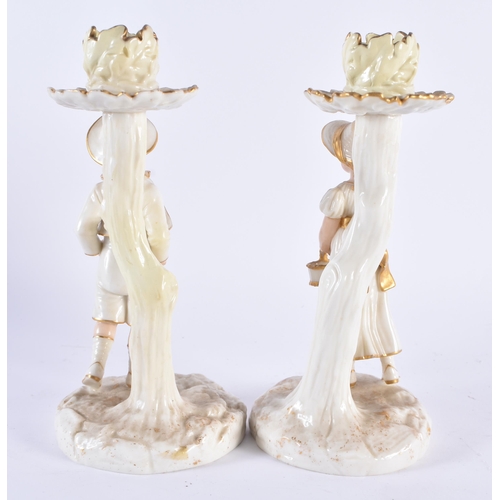 131 - A PAIR OF ROYAL WORCESTER PORCELAIN CANDLESTICKS formed with figures. 19 cm high.