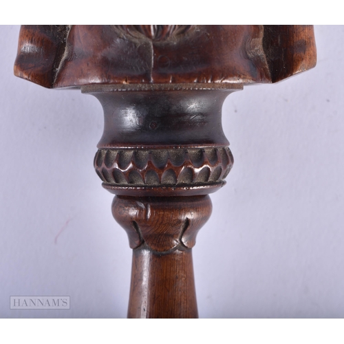 135A - AN EARLY 19TH CENTURY CARVED FRUITWOOD TREEN NUT CRACKER formed as a half torso. 19 cm x 7 cm