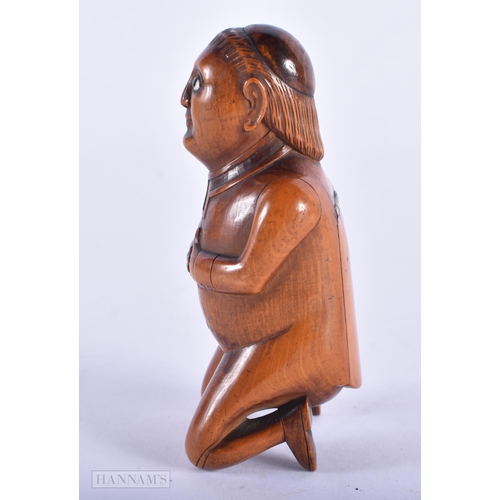 135C - A LOVELY EARLY 19TH CENTURY CARVED FRUITWOOD TREEN SNUFF BOX formed as a male with hands clasped upo... 