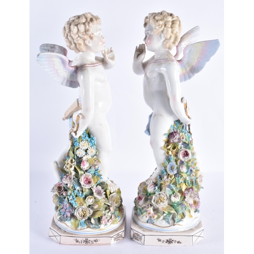 146 - A LARGE PAIR OF EARLY 20TH CENTURY CONTINENTAL PORCELAIN PUTTI modelled upon encrusted bases. 36 cm ... 