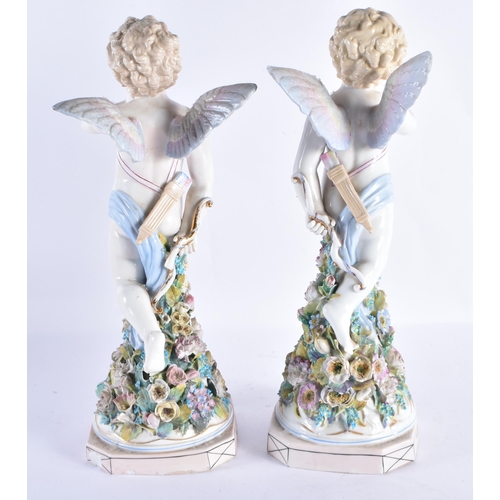 146 - A LARGE PAIR OF EARLY 20TH CENTURY CONTINENTAL PORCELAIN PUTTI modelled upon encrusted bases. 36 cm ... 