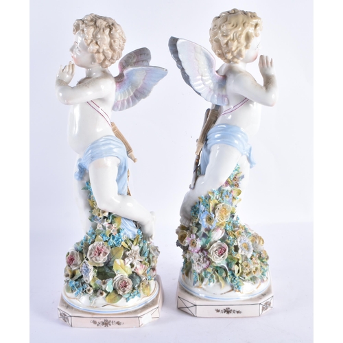 146 - A LARGE PAIR OF EARLY 20TH CENTURY CONTINENTAL PORCELAIN PUTTI modelled upon encrusted bases. 36 cm ... 