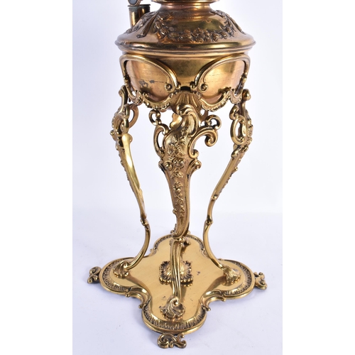 158 - A LARGE ANTIQUE BRASS OIL LAMP with scrolling legs. 65 cm high.