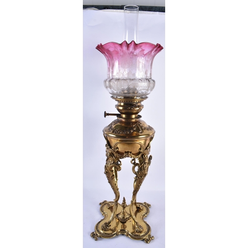 158 - A LARGE ANTIQUE BRASS OIL LAMP with scrolling legs. 65 cm high.