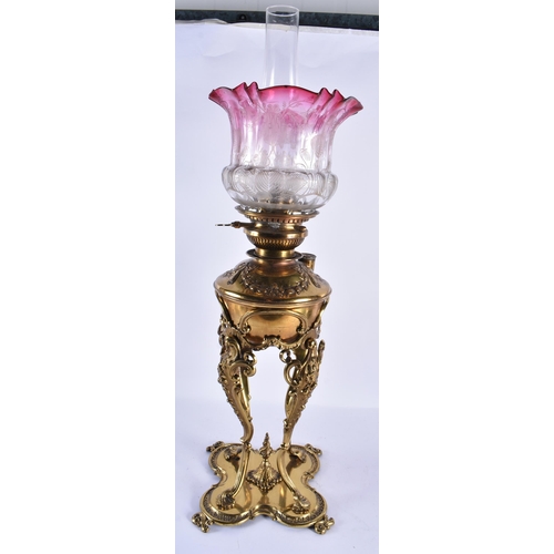 158 - A LARGE ANTIQUE BRASS OIL LAMP with scrolling legs. 65 cm high.