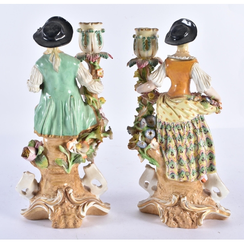 166 - A PAIR OF 18TH CENTURY DERBY PORCELAIN CANDLESTICKS formed as a male and female. 26 cm high.