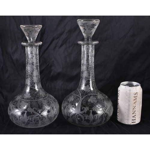 181 - A PAIR OF ANTIQUE ENGRAVED GLASS SHIPS DECANTERS AND STOPPERS. 30 cm high.