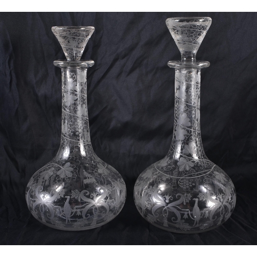 181 - A PAIR OF ANTIQUE ENGRAVED GLASS SHIPS DECANTERS AND STOPPERS. 30 cm high.