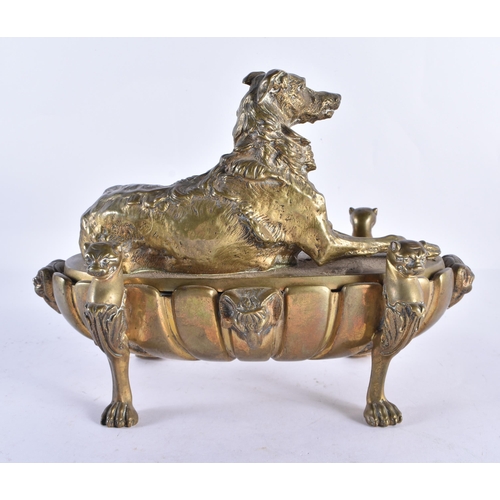 196 - A LARGE 19TH CENTURY BRONZE DESK STAND INKWELL AND COVER mounted with a recumbant hound. 26 cm x 20 ... 