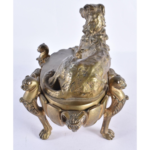 196 - A LARGE 19TH CENTURY BRONZE DESK STAND INKWELL AND COVER mounted with a recumbant hound. 26 cm x 20 ... 