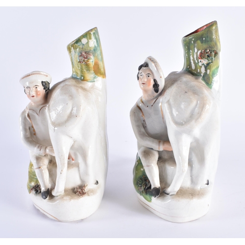 20 - A PAIR OF 19TH CENTURY STAFFORDSHIRE POTTERY COW SPILL VASES modelled with attendants. 18 cm x 14 cm... 