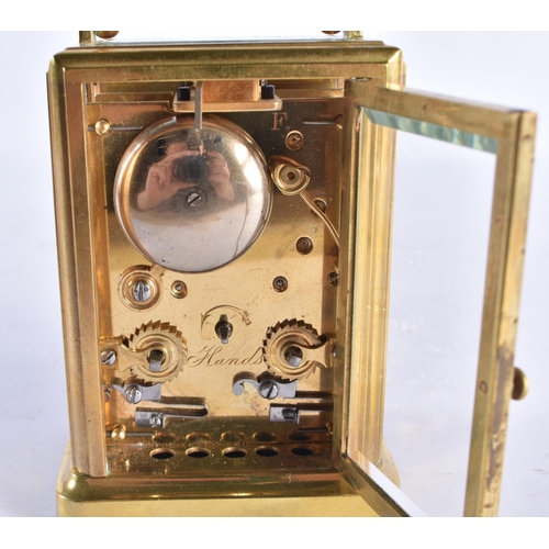 207 - A SMALL ANTIQUE BRASS CARRIAGE CLOCK. 14 cm high inc handle.