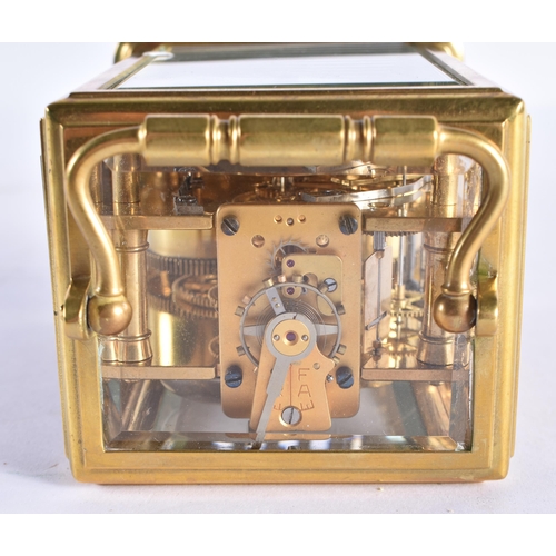 207 - A SMALL ANTIQUE BRASS CARRIAGE CLOCK. 14 cm high inc handle.