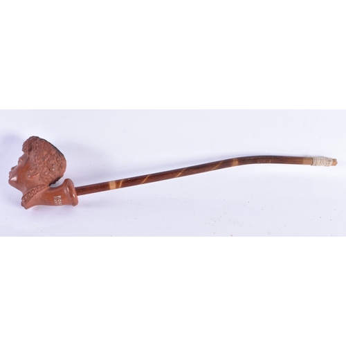 216 - A VINTAGE FRENCH TERRACOTTA NUBIAN PIPE. 22 cm long.