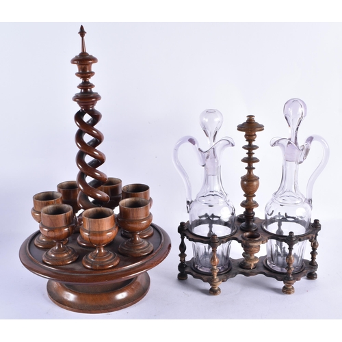 246 - AN ANTIQUE TREEN EGG CUP HOLDER together with a treen carved wood liquor set. Largest 40 cm high. (2... 