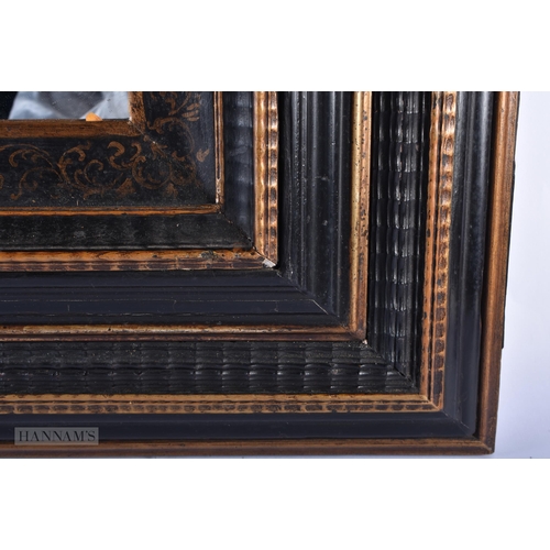 25A - A LARGE 18TH/19TH CENTURY CONTINENTAL EBONISED PENWORK MIRROR of square form with canted graduated c... 