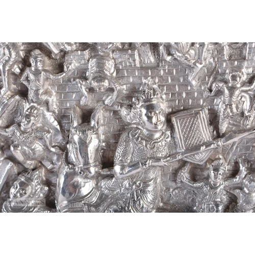 25D - A RARE LARGE 19TH CENTURY INDIAN BURMESE SILVER REPOUSSE PLAQUE decorated with numerous figures in v... 