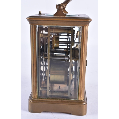 297 - AN ANTIQUE FRENCH BRASS CARRIAGE CLOCK. 17 cm high inc handle.