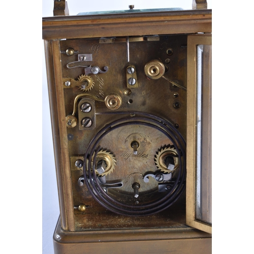 297 - AN ANTIQUE FRENCH BRASS CARRIAGE CLOCK. 17 cm high inc handle.