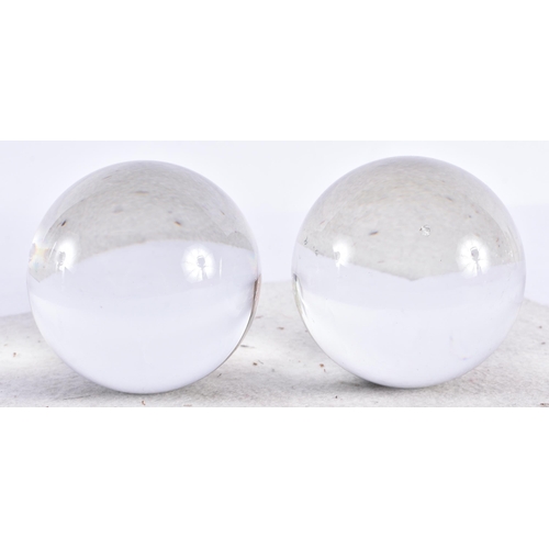 309 - A PAIR OF FORTUNE TELLERS CRYSTAL GLASS BALLS. 7.5 cm wide.