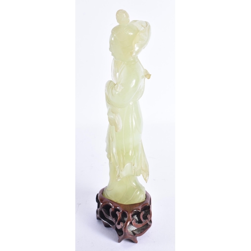 313 - AN EARLY 20TH CENTURY CHINESE CARVED JADE FIGURE OF A FEMALE Late Qing. 18 cm high.