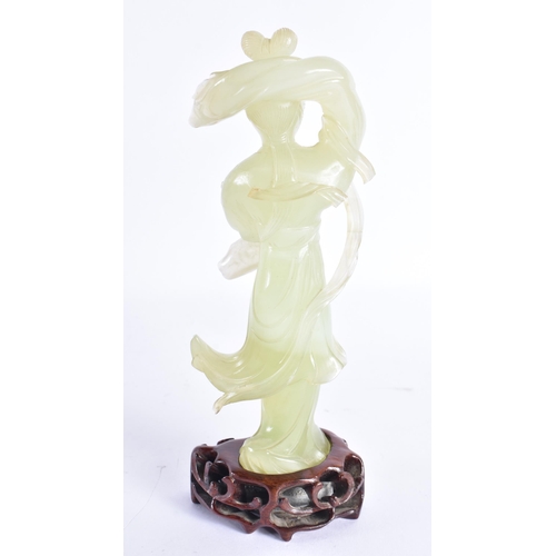 313 - AN EARLY 20TH CENTURY CHINESE CARVED JADE FIGURE OF A FEMALE Late Qing. 18 cm high.