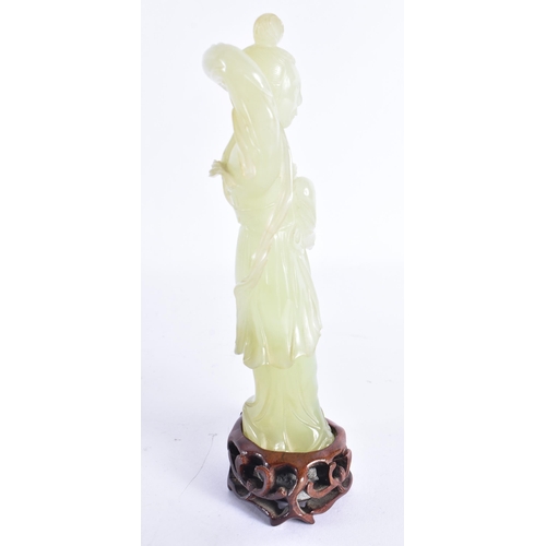 313 - AN EARLY 20TH CENTURY CHINESE CARVED JADE FIGURE OF A FEMALE Late Qing. 18 cm high.