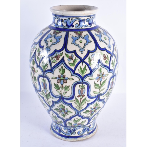 315 - A LARGE MIDDLE EASTERN PERSIAN IZNIK POTTERY VASE painted with stylised flowers. 38 cm x 20 cm.