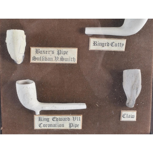 322 - A UNUSUAL ANTIQUE CLAY PIPE DISPLAY. 38 cm x 28 cm.