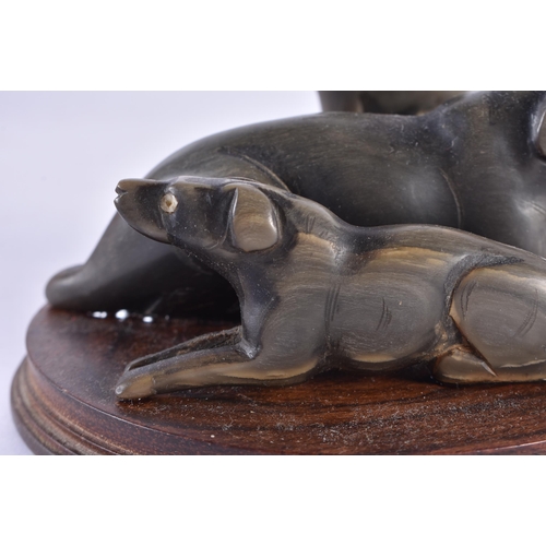 358 - A RARE 19TH CENTURY ANGLO INDIAN CARVED RHINOCEROS HORN DOG GROUP. 12 cm x 12 cm.