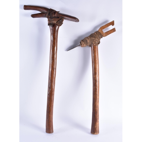 365 - A PAIR OF TRIBAL CARVED WOOD AXE TYPE WEAPONS. 60 cm long. (2)